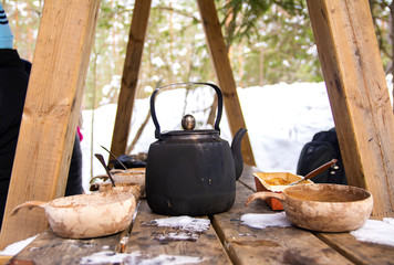 Picnic with tea in kettle and pie in cold winter day, Espoo, Finland