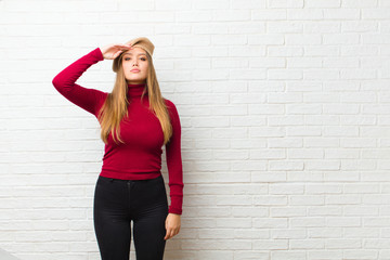 young artist woman greeting the camera with a military salute in an act of honor and patriotism,...