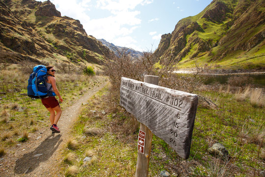 A femal backpacker walks byt the Pittsburg Landing trailhead for the scenic Snake River National Recreation Trail (#102) in Hells Canyon along the Oregon-Idaho border.