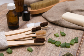 smile from aloe slices, bamboo toothbrushes and other bath accessories on a wooden table in the bathroom, eco friendly concept, natural cosmetics