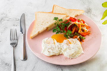 Poached eggs with vegetable and sourdough toast isolated on white marble background. Homemade food. Tasty breakfast. Selective focus. Hotizontal photo.