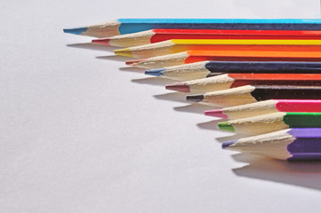 multicolored pencils on a white background