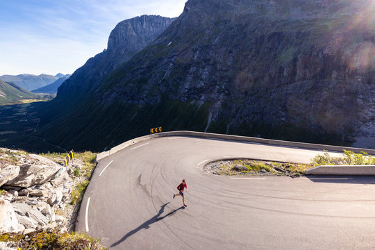 Trollstigen, Romsdalen, Norway: A male runner on the famouse narrow pass road.