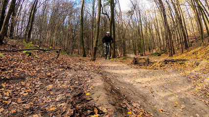 Amateur rider on the bicycle in the autumn park