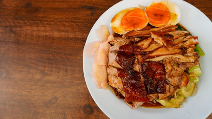Roast duck with rice on a wooden 