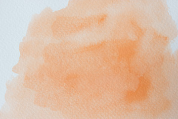 Abstract orange watercolor on white background.