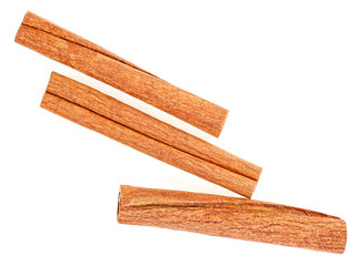 Cannelle. Three cinnamon sticks isolated on a white background, top view.