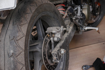 The process of replacing brake pads on a motorcycle.