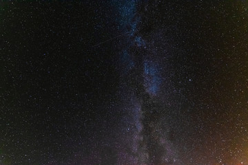 starry night with the Milky Way on the Turkish Mediterranean coast amidst the rocky mountains with tourists in a yellow tent