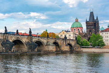 Obraz premium Prague cityscape with Old Town Bridge Tower and Charles bridge over Vltava river, Czech Republic