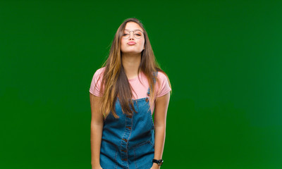 young pretty woman feeling nervous and hopeful, crossing fingers, praying and hoping for good luck...