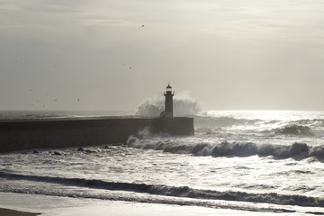 lighthouse with rough waves as background