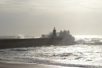 lighthouse with rough waves as background