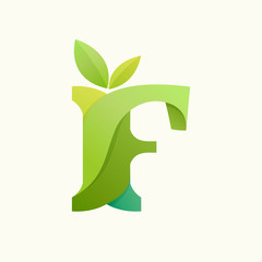 Swirling letter F logo with green leaves.