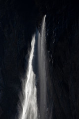 Fototapeta na wymiar Sun light through a waterfall, Staubbach, Switzerland