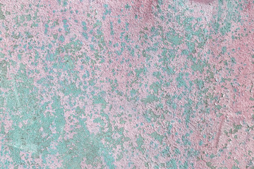 Abstract background with cracked and peeling paint. Old metal sheet with remains of pink and blue paint. For layouts and sites.