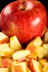 whole red apple with small pieces