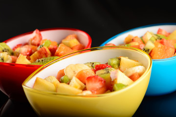 fruit salad in colorful bowls