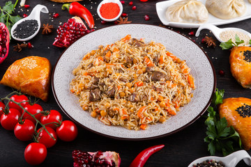 The concept of Eastern asian festive cuisine. Assorted Uzbek food set, pilaf, samsa, lagman, manta, shurpa restaurant concept, Uzbek food. Homemade Eastern arabic new year and Christmas dish from lamb