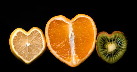 Tasty juicy fruit lemon orange kiwi in the shape of a heart