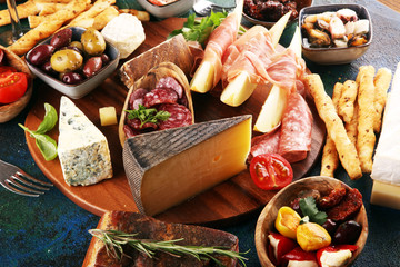 Italian antipasti wine snacks set. Cheese variety, Mediterranean olives, seafood salad, Prosciutto...