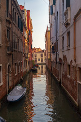 Venice, Italy. Boats in a narrow canal between old houses