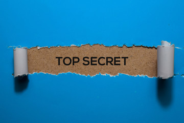 Top Secret write on blue torn paper