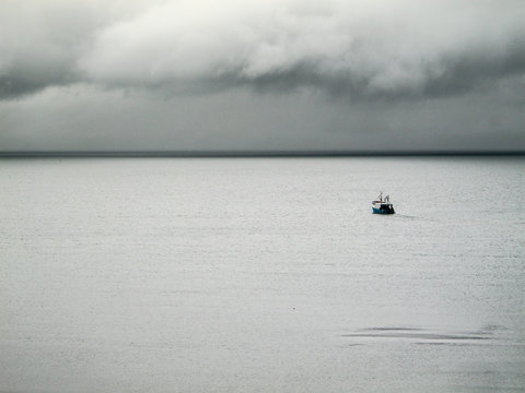 single small boat in the sea quiet before storm