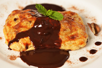 Puff pastry with chocolate filling and mint leaf with cinnamon powder
