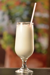 coconut cocktail with cinnamon and crystallized sugar