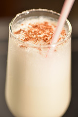 coconut cocktail with cinnamon and crystallized sugar