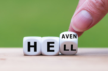 Hell or heaven? Hand turns a dice and changes the word 