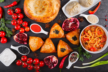 The concept of Eastern asian festive cuisine. Assorted Uzbek food set, pilaf, samsa, lagman, manta, shurpa restaurant concept, Uzbek food. Homemade Eastern arabic new year and Christmas dish from lamb
