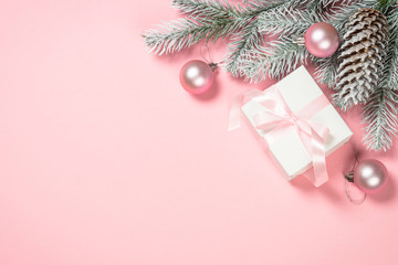 Christmas flat lay background with christmas present box on pink.