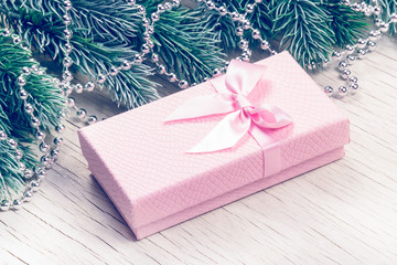 Beautiful christmas gift box close up. Pink gift box with bow