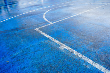 Wet blue outdoor basketball court 