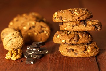 Unhealthy food. Chocolate cookies on wooden table. Chocolate chip cookies shot. Risk of obesity and diabetes. Chocolate and nuts.
