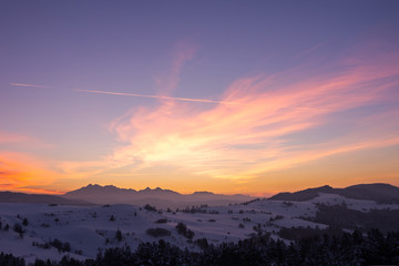sunset in the snowy mountains at winter