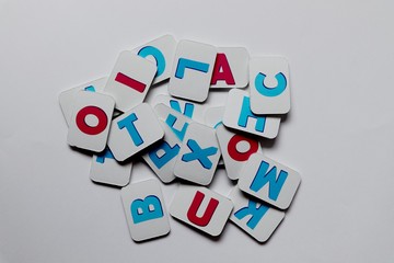 Many cards with different letters of the alphabet on a white background