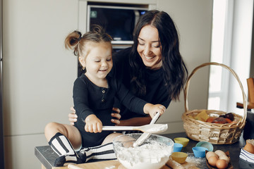 Family in a kitchen. Beautiful mother with little daughter