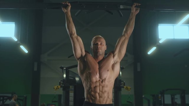 Handsome strong athletic men pumping up muscles workout fitness and bodybuilding concept background - muscular bodybuilder fitness men doing abs exercises in gym naked torso