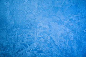Frozen window patterns. Blue background. Abstraction. Frost