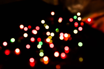 unfocused blurry glowing red, green and yellow lights on black background