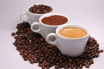 Three cups of coffee beans, powder and liquid - 304212194