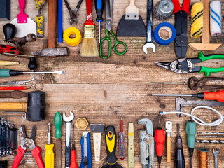 Construction tool on a wooden background.