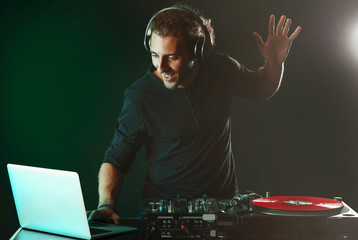 Male dj playing music in nightclub