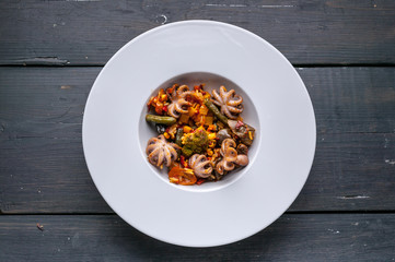 Top view Vegetarian paella with octopus on a white plate. Mediterranean food. Ketogenic Diet Recipes