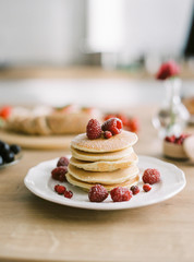 white plate with delicious pancakes on table