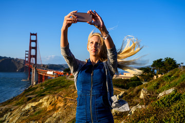 Strong wind at the Golden Gate Bridge blowing into her blond hair
