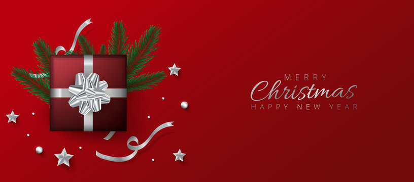 Red header or banner design decorated with gift box, baubles and pine leaves for Merry Christmas and Happy New Year.